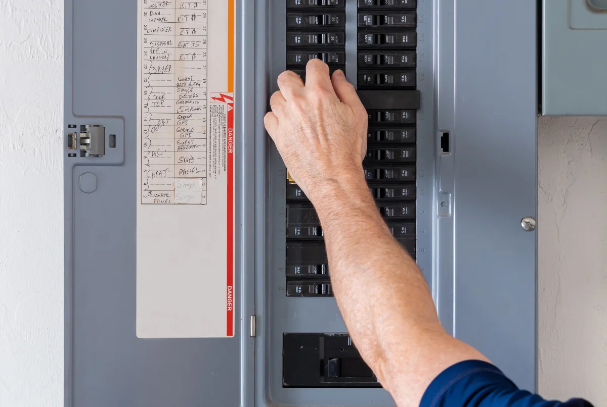 Electrician working on circuit breaker panel